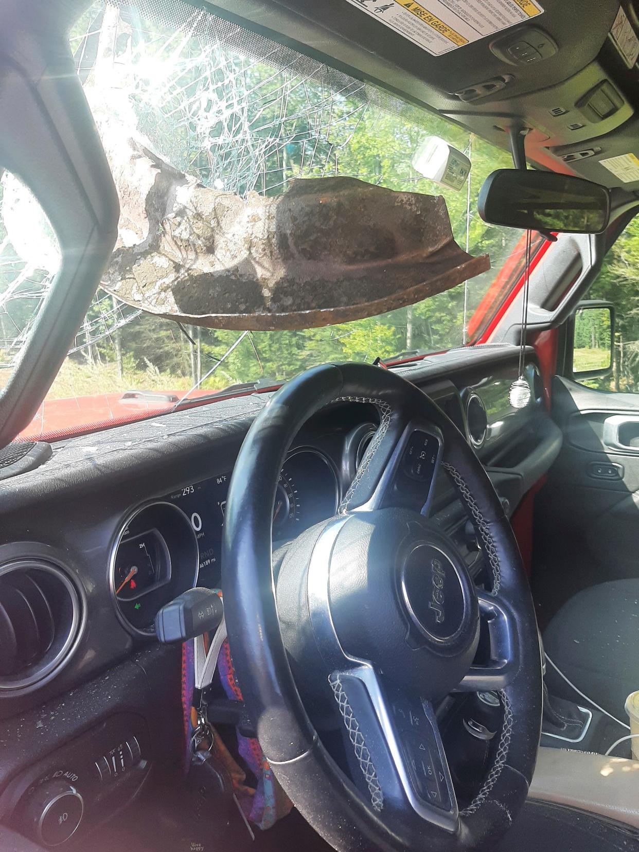 This photo provided by the Maine State Police shows a Jeep that was struck by a piece of metal that came within inches of a motorist's face, on the Maine Turnpike, in Gray, Maine, on Tuesday, Sept. 5, 2023. Police said the 21-year-old motorist from New Hampshire was following a vehicle that ran over the metal road debris, sending it flying into the windshield of her Jeep Wrangler.