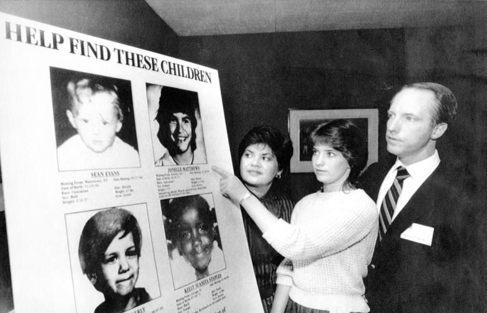 Jennifer Matthews, then 16, points to a photo of her missing sister, Jonelle, who was 12 when she disappeared, as their parents, Gloria and Jim Matthews, look on April 19, 1985, in New York. Playhouse Video announced a poster program as part of a campaign to help locate missing children that it hoped would involve 24,000 nationwide video retail outlets and be seen by 144 million customers.