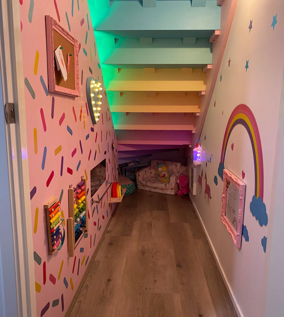 Under stair space transformed in pink and rainbow playroom with Kmart LED lights