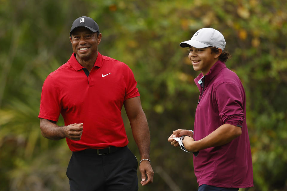 Tiger Woods reacts after his son, Charlie Woods, chips in for a birdie on the ninth green during the final round of the PNC Championship at The Ritz-Carlton Golf Club on Dec. 17, 2023 in Orlando. (Photo by Mike Ehrmann/Getty Images)