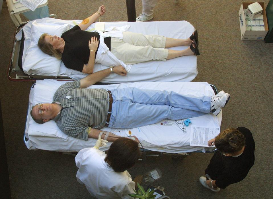 Volunteers donate blood at a blood donation station set up to help victims of the attack on the World Trade Center in New York City on September 11, 2001, at Lutheran General Hospital in Park Ridge, Illinois.