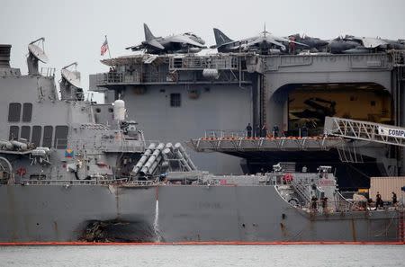 The damaged USS John McCain is docked next to USS America at Changi Naval Base in Singapore August 22, 2017. REUTERS/Calvin Wong