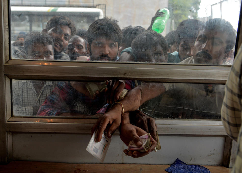 Laborers buy bus tickets at a counter of Jammu and Kashmir Tourist Reception Centre (JKTRC) in Srinagar on Aug. 7 | Sajjad Hussain—AFP/Getty Images