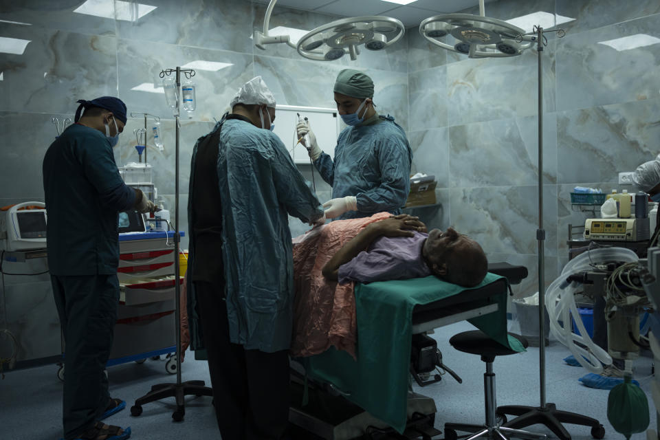 Dr. Suhaib Alhamss, the director of the Kuwaiti Hospital in Gaza's southern town of Rafah, performs surgery on a patient during his work day. Thursday, Jan. 11, 2024. Overwhelmed with the dead and wounded as Rafah's population swells with displaced people, Alhamss has struggled to save lives as his hometown and hopsital have transformed over the 100 days of the Israel-Hamas war. (AP Photo/Fatima Shbair)