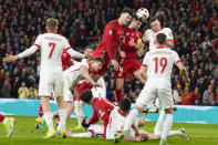 Welsh players Kieffer Moore and Ben Davies compete to head the ball at goal during Euro 2024 soccer play-off match between Wales and Poland at Cardiff City Stadium, Wales, Tuesday, March 26, 2024. (AP Photo/Alastair Grant)