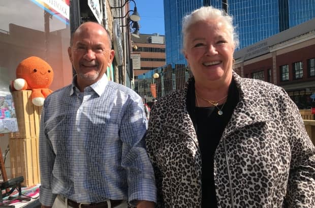 This married couple from Vancouver, B.C., Al Mitchell and Pam Owen, were pictured enjoying a warm, sunny day in downtown St. John's earlier this month. They were among a large number of visitors exploring the city. (Terry Roberts/CBC - image credit)