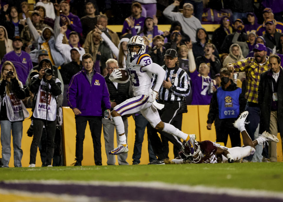 LSU wide receiver Trey Palmer (33) runs past Texas A&M defensive back Jardin Gilbert (20) for a touchdown during the second quarter of an NCAA college football game in Baton Rouge, La., Saturday, Nov. 27, 2021. (AP Photo/Derick Hingle)