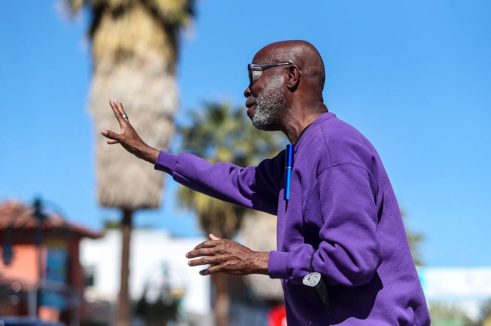 Jessay Martin of Palm Springs TikTok group The Old Gays waves to participants in the 35th annual Palm Springs Black History parade in downtown Palm Springs, Calif., Saturday, Feb. 26, 2022.