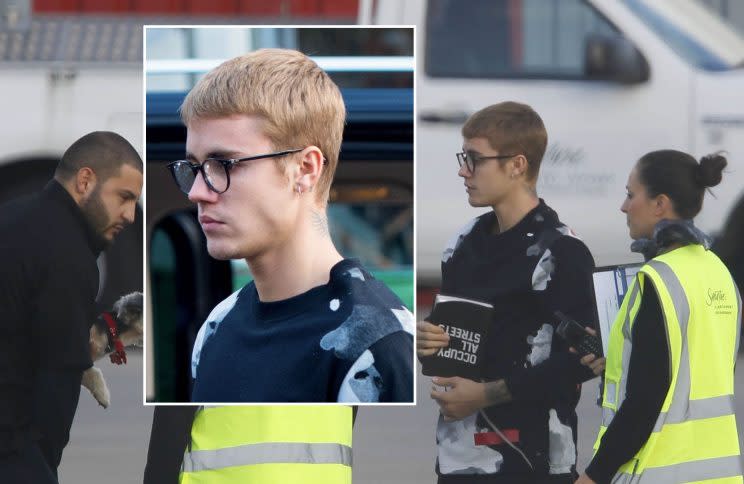 Picture Shows: Justin Bieber October 10, 2016 *Min Fee £150 Per Pic For Mags* Double Fees For Cover Use Justin Bieber lands at Luton Airport on a private jet with a little dog. The pop star made his security carry the dog as Bieber wearing glasses talked with ground staff. The multi millionaire was holding what appeared to be a book which said 