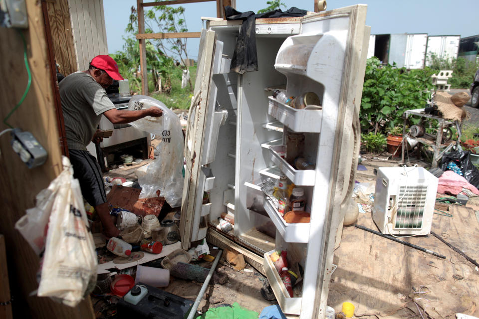 FILE PHOTO: Jose Taveras sorts things in the remains of his home, after the island was hit by Hurricane Maria in September, in Toa Alta, Puerto Rico October 19, 2017. REUTERS/Alvin Baez/File Photo