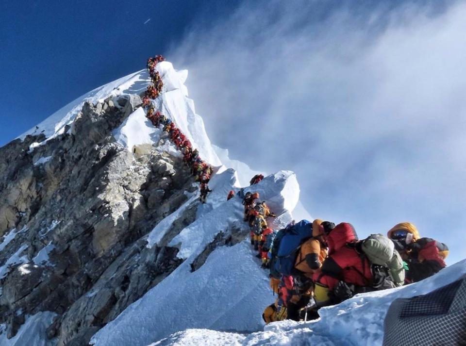 This infamous photo from 2019 showing the “traffic jam” atop Everest and dozens of climbers waited to reach its peak. AP