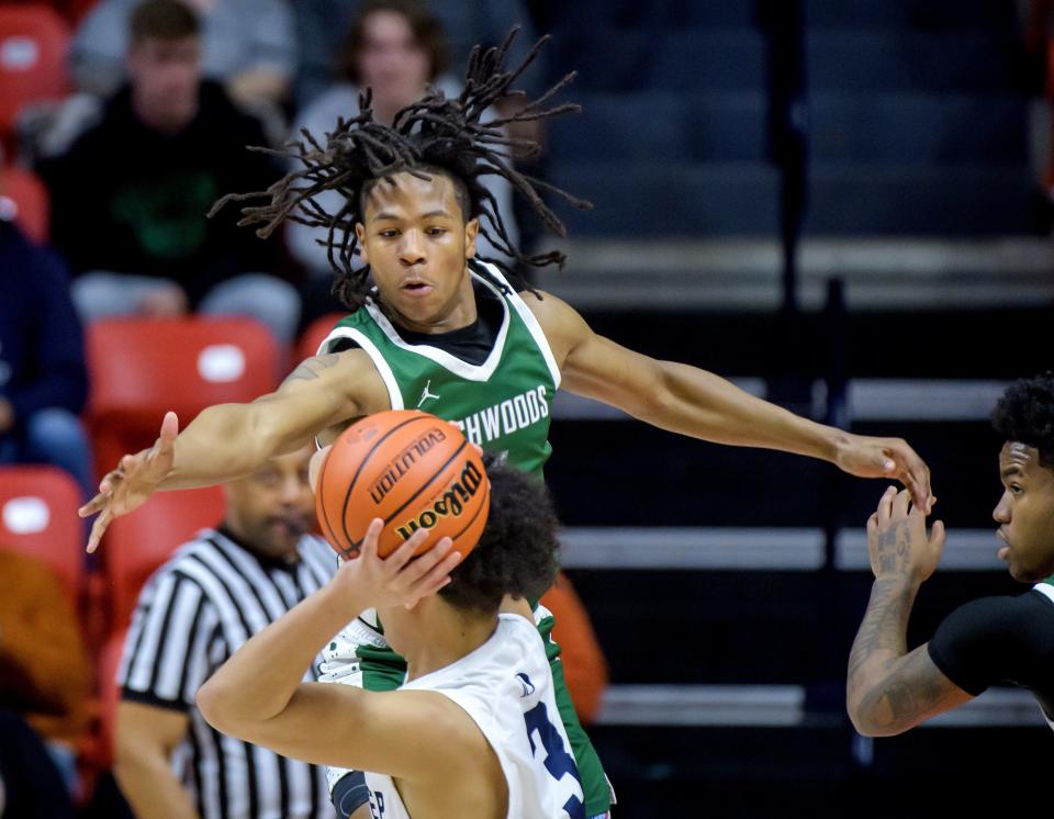 Richwoods' Tavie Smith gets up high to defend DePaul College Prep's AJ Chambers in the first half of the Class 3A boys basketball state semifinals Friday, March 8, 2024 at the State Farm Center in Champaign. The Knights fell to the Rams 52-41.