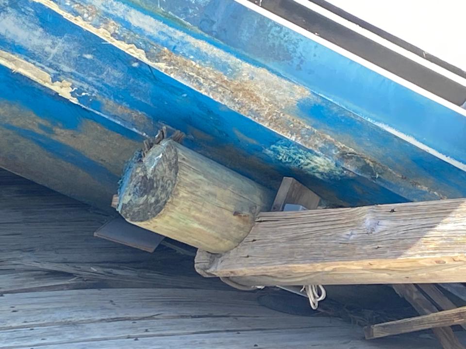 This is a dock post crushed by "Batchelor Pad" when it was ripped from its slip during Hurricane Ian. It ended up on the dingy dock at Bonita Bill's. What you can see are two dock posts under the boat. They impaled the boat keeping it in place.