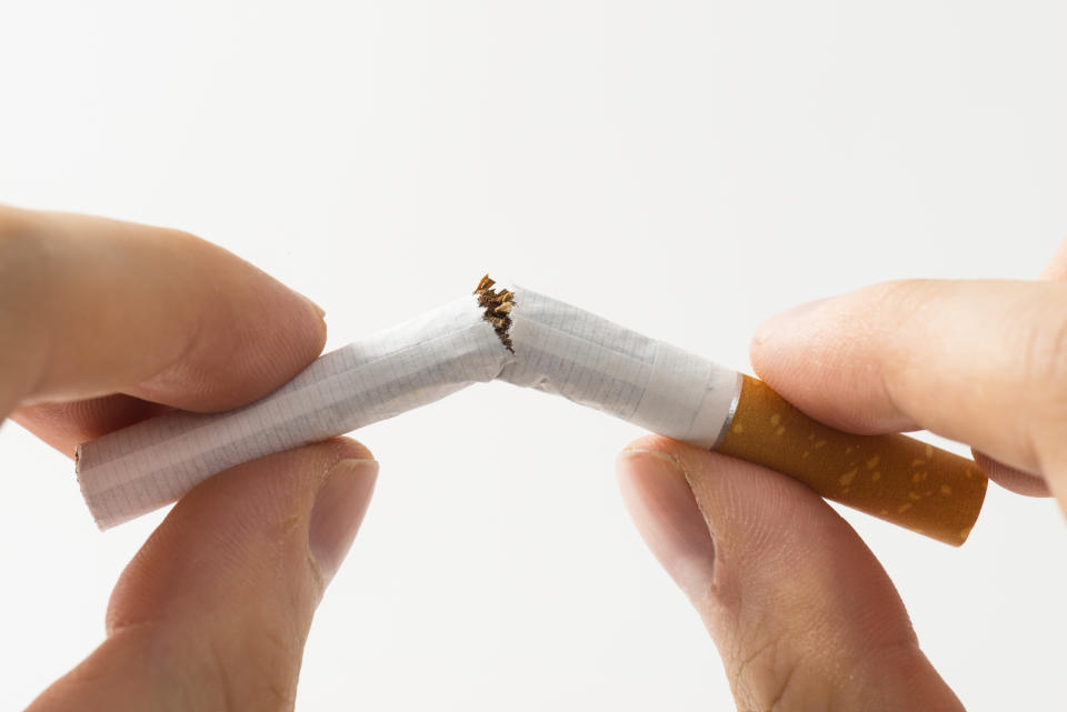 Cigarette broken in half, isolated on white.