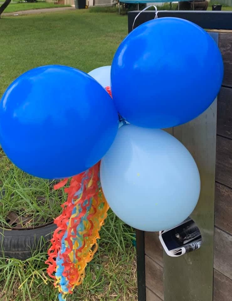 Pictured are blue balloons on a newsletter. 