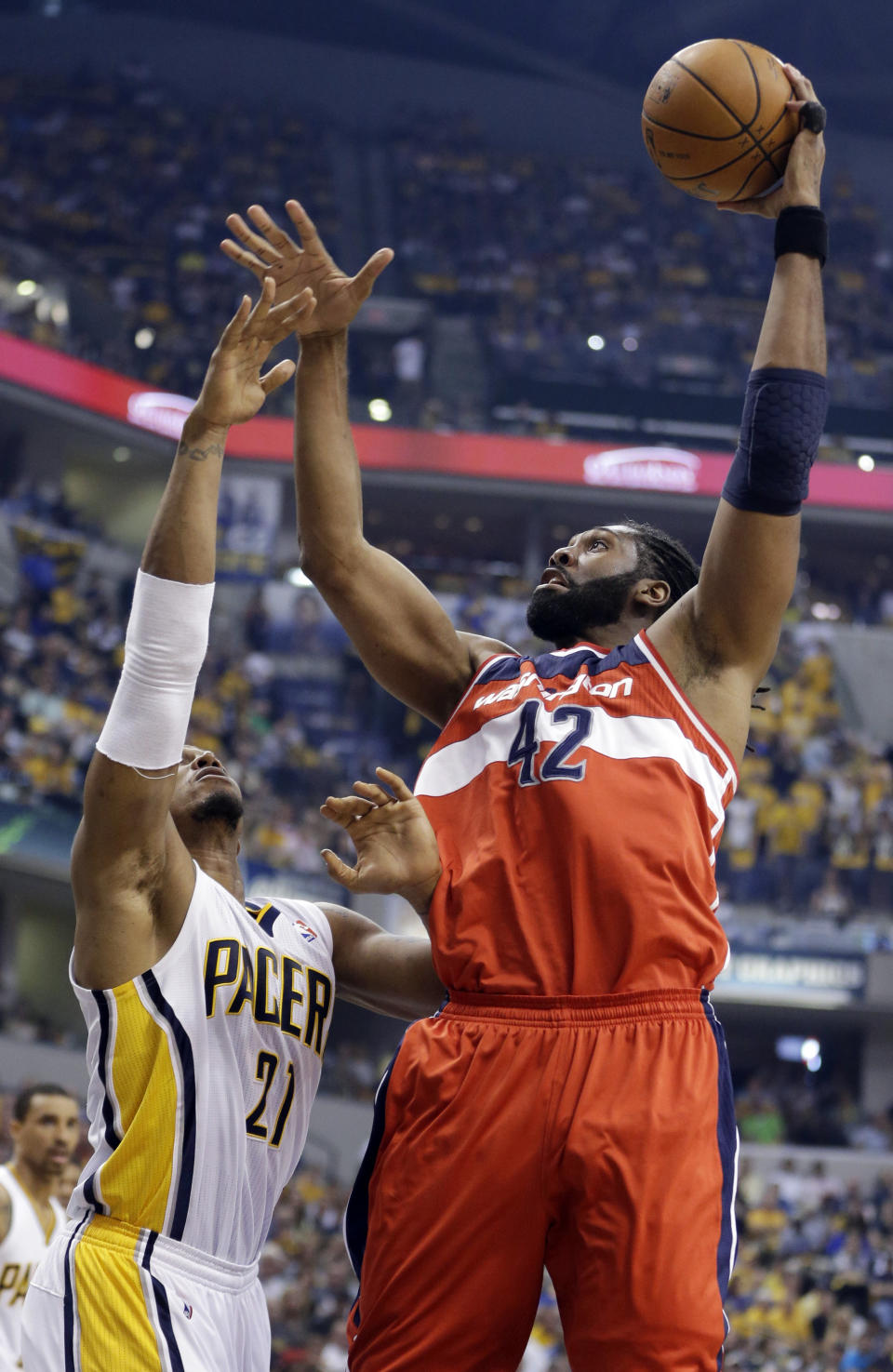 Washington Wizards forward Nene Hilario, right, shoots over Indiana Pacers forward David West during the first half of game 2 of the Eastern Conference semifinal NBA basketball playoff series on Wednesday, May 7, 2014, in Indianapolis. (AP Photo/Darron Cummings)