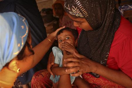 Musana Khatu, a 22-month-old Rohingya girl suffering from diarrhoea for 13 days, undergoes examination after her mother brought her from the Baw Dupa camp for internally displaced people to a makeshift clinic at the Thet Kae Pyin camp in Sittwe, Rakhine state, April 23, 2014. REUTERS/Minzayar