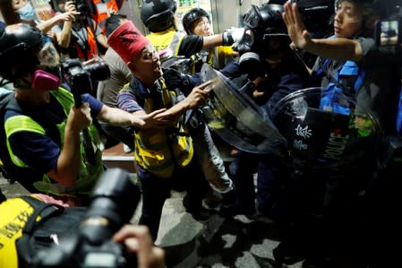 Anti-government protesters clash with the police near Yuen Long station, in Hong Kong