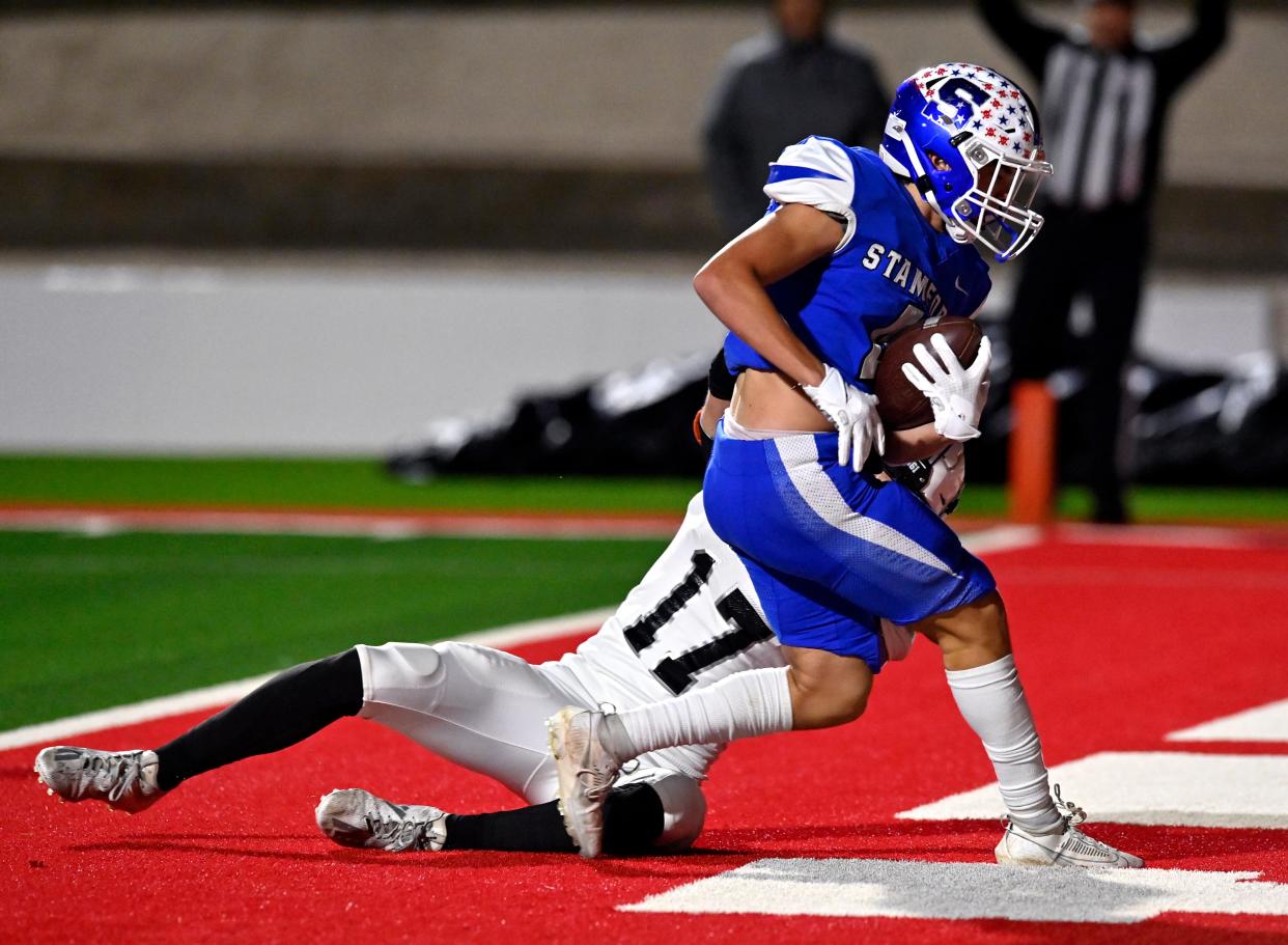 Stamford wide receiver Drew Faulks drags Forsan defensive back Brooks Wright into the end zone with him as Faulks scores a touchdown during Friday’s Class 2A Div. I bi-district playoff game at the Mustang Bowl in Sweetwater Nov. 10, 2023. Final score was 42-6, Stamford.