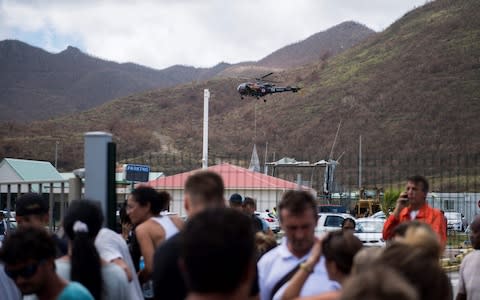 A helicopter of French army brings food to the Grand-Case Esperance airport, on Saint-Martin island - Credit: AFP