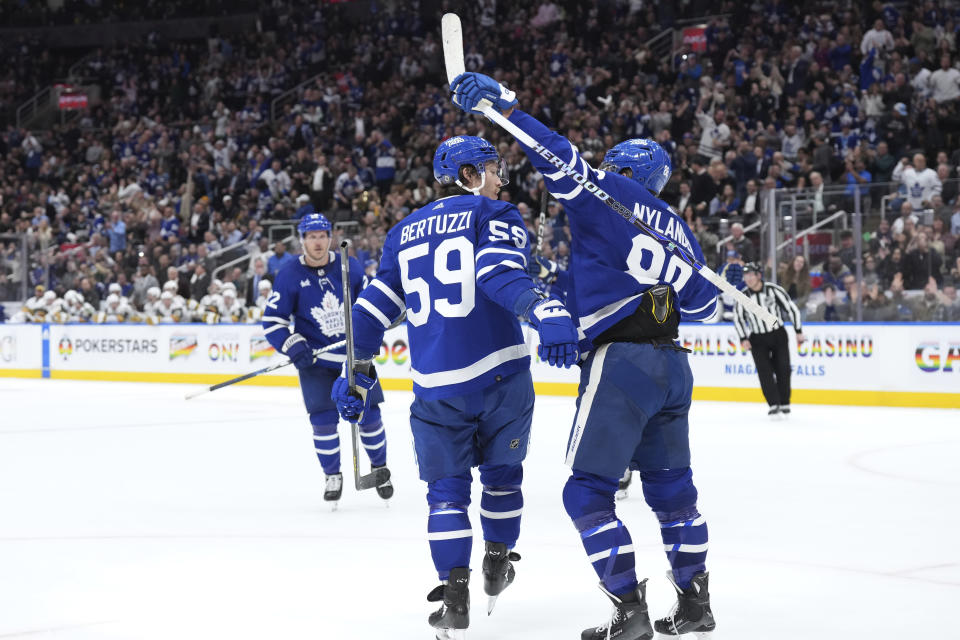 Toronto Maple Leafs' Tyler Bertuzzi (59) celebrates with William Nylander (88) after scoring against the Vegas Golden Knights during the second period of an NHL hockey game in Toronto, on Tuesday, Feb. 27, 2024. (Chris Young/The Canadian Press via AP)