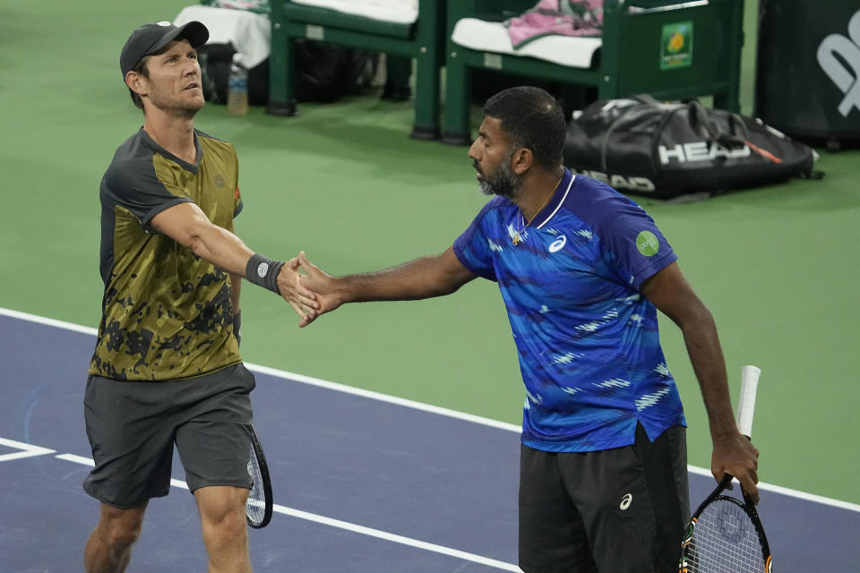 Matthew Ebden, of Australia, left, celebrates with teammate Rohan Bopanna, of India, after winning a point against Wesley Koolhof, of the Netherlands, and Neal Skupski, of Britain, during the men's doubles final at the BNP Paribas Open tennis tournament Saturday, March 18, 2023, in Indian Wells, Calif. (AP Photo/Mark J. Terrill)