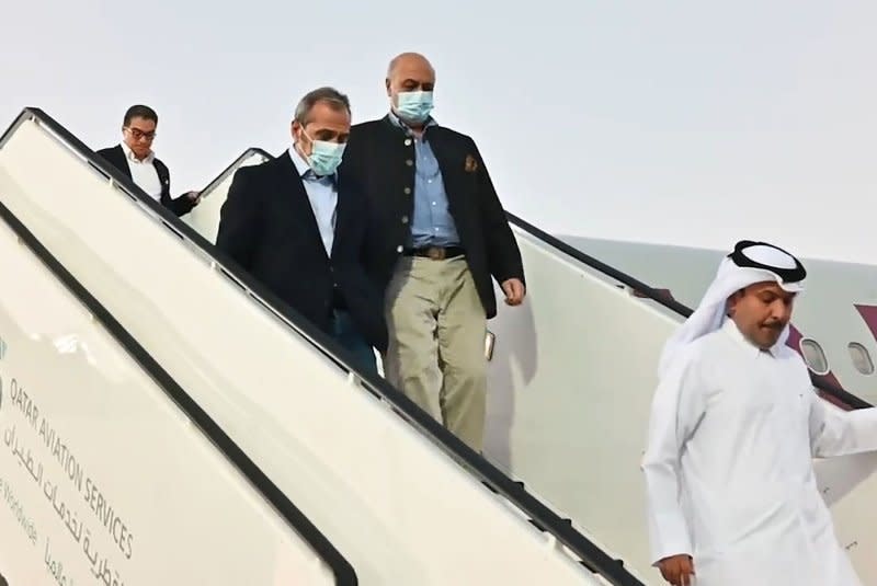 U.S. citizens Siamak Namazi (L), Emad Sharqi (2L) and Morad Tahbaz (2R) are greeted upon their arrival at the Doha International Airport in Qatar on Monday after they were released as part of a a Qatari-mediated prisoner exchange deal between Iran and the United States. Photo by Qatar News Agency