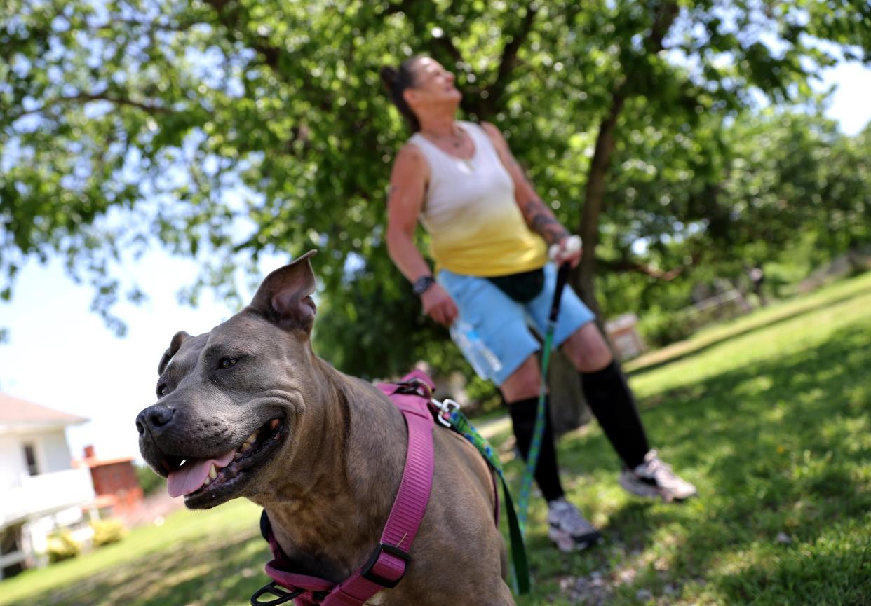 Tricia Wheeler and her dog, Sierra Bear, wait outside the former Crossbridge Community Church building recently to get pet food from the Pet Food Pantry of Oklahoma.