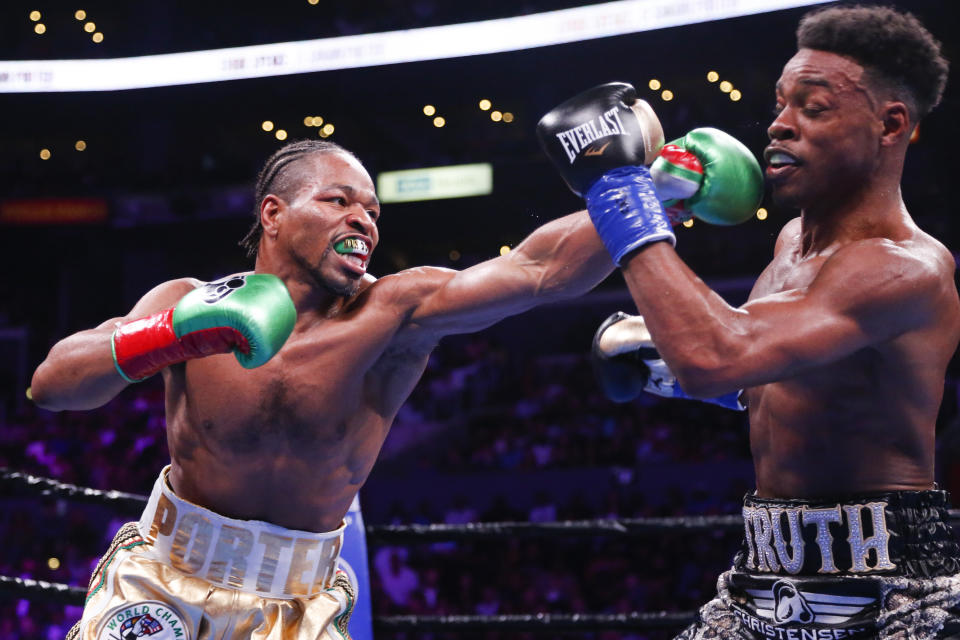 Errol Spence Jr., right, and Shawn Porter exchange punches during the WBC & IBF World Welterweight Championship boxing match Saturday, Sept. 28, 2019, in Los Angeles. (AP Photo/Ringo H.W. Chiu)