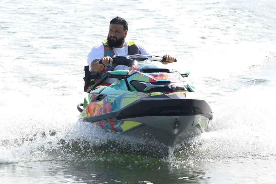 <p>DJ Khaled enjoys a ride on his colorful jet ski with his wife (not pictured) on Friday in Miami Beach.</p>