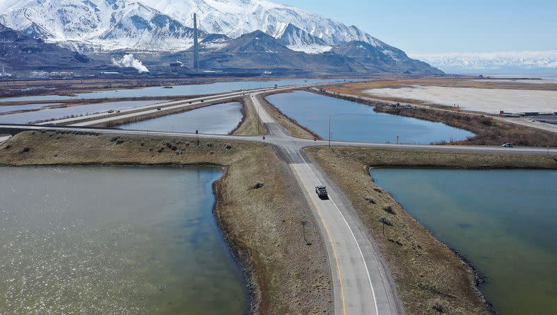 Motorists drive on I-80 and exits near the Great Salt Lake in Salt Lake City on Friday, March 17, 2023. One of the world’s largest hypersaline lakes, the Great Salt Lake is on the verge of collapse due to climate change, drought and population pressures that have reduced inflows and shrunk the lake by more than two-thirds.