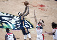 New Orleans Pelicans forward Brandon Ingram (14) shoots over Washington Wizards guard Raul Neto (19) in the third quarter of an NBA basketball game in New Orleans, Wednesday, Jan. 27, 2021. (AP Photo/Derick Hingle)