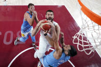 Spain's Marc Gasol, center, drives to the basket against Argentina's Facundo Campazzo (7) during a men's basketball preliminary round game at the 2020 Summer Olympics, Thursday, July 29, 2021, in Saitama, Japan. (AP Photo/Eric Gay)
