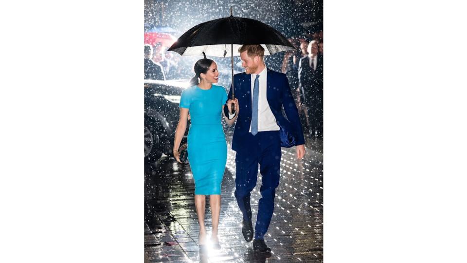 Meghan Markle with her husband Prince Harry in the rain 