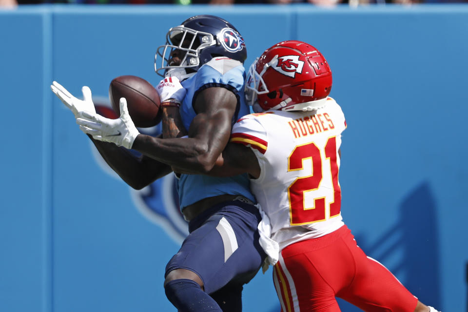 Tennessee Titans wide receiver A.J. Brown, left, catches a touchdown pass as he is defended by Kansas City Chiefs cornerback Mike Hughes (21) in the first half of an NFL football game Sunday, Oct. 24, 2021, in Nashville, Tenn. (AP Photo/Wade Payne)