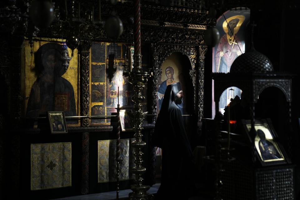 A monk attends the afternoon prayers at the Pantokrator Monastery in the Mount Athos, northern Greece, on Thursday, Oct. 13, 2022. The monastic community was first granted self-governance through a decree by Byzantine Emperor Basil II, in 883 AD. Throughout its history, women have been forbidden from entering, a ban that still stands. This rule is called "avaton" and the researchers believe that it concerns every form of disturbance that could affect Mt. Athos. (AP Photo/Thanassis Stavrakis)