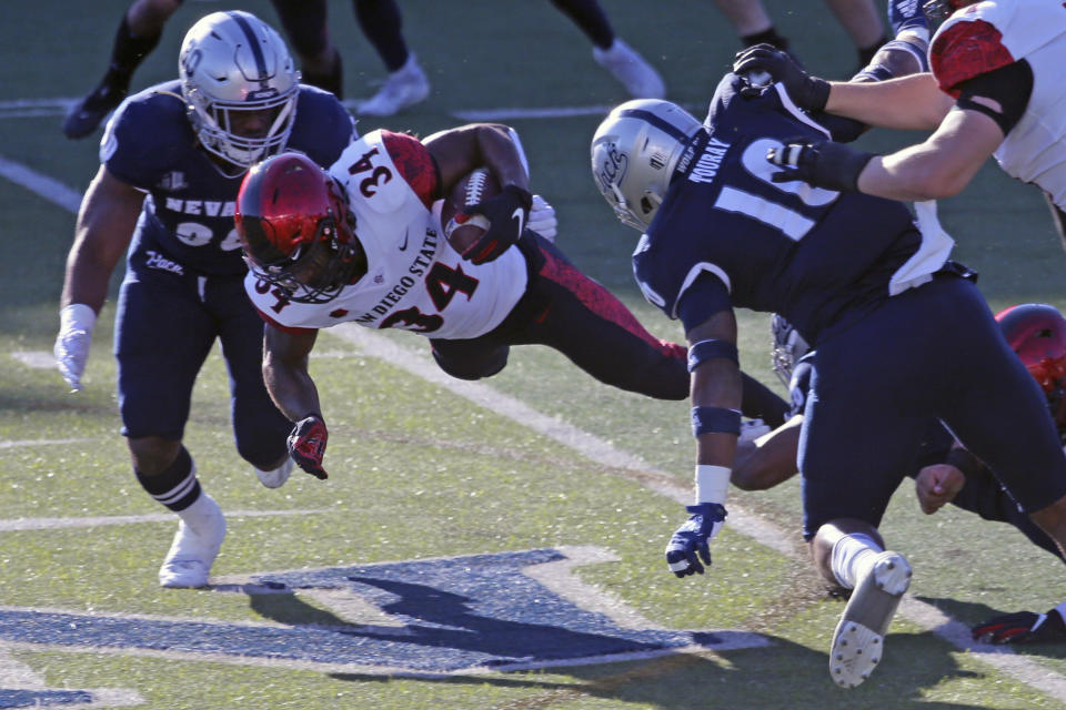 San Diego State running back Greg Bell runs for a first down against Nevada during the first half of an NCAA college football game Saturday, Nov. 21, 2020, Reno, Nev. (AP Photo/Lance Iversen)