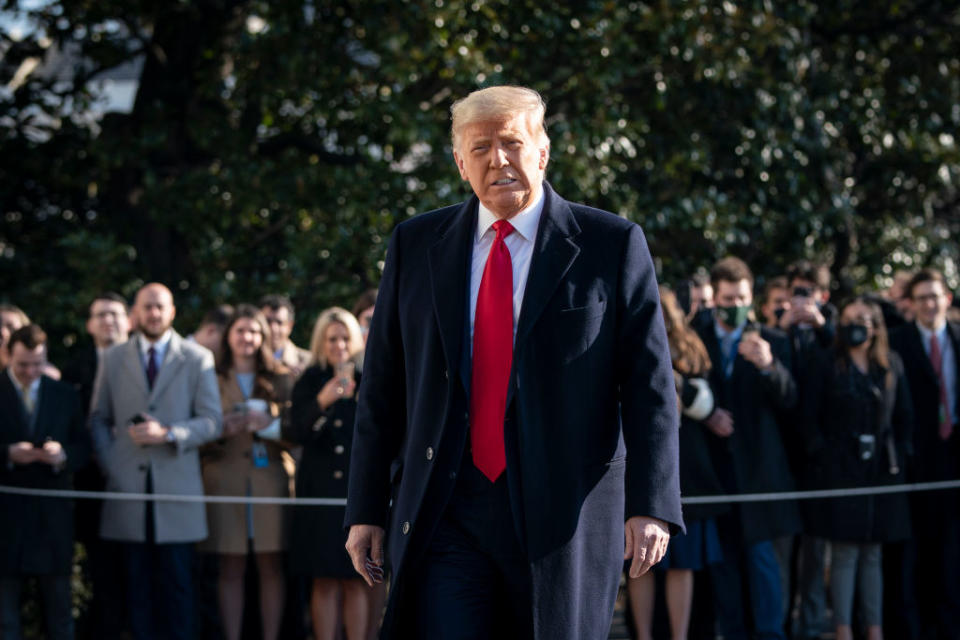 US President Donald Trump turns to reporters as he exits the White House to walk toward Marine One.