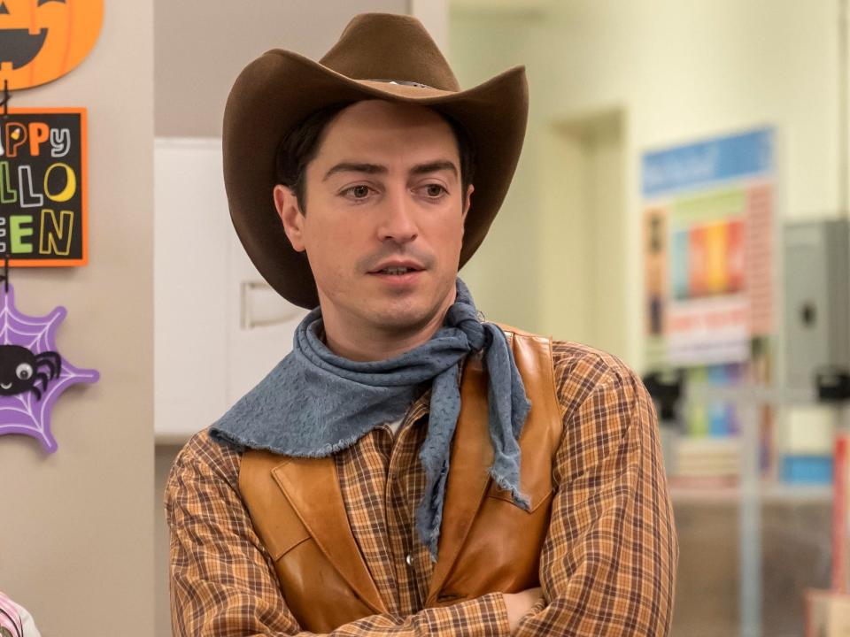 man dressed as a cowboy with hat and scarf