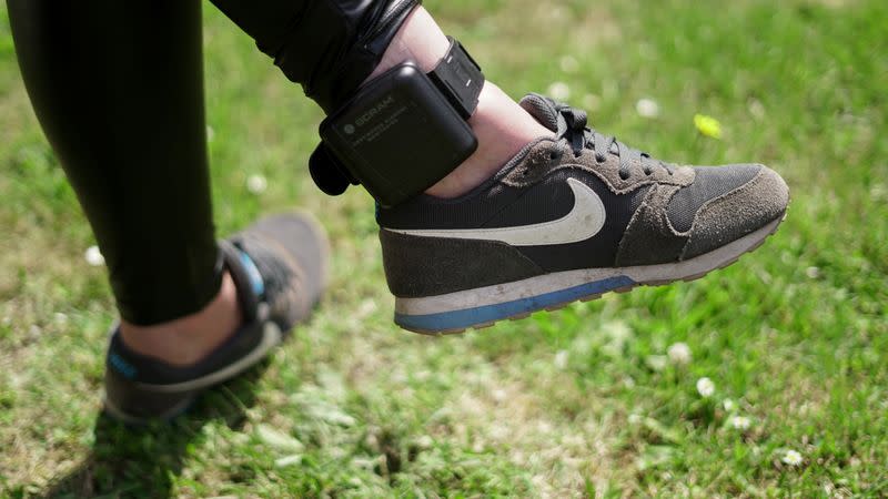 An unidentified woman displays an ankle strap called "alcoholmeter" in Zutphen