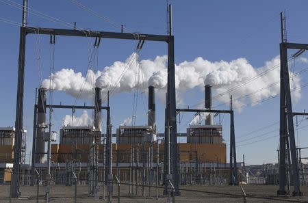 Steam rises from the stakes of the coal-fired Jim Bridger Power Plant outside Point of the Rocks, Wyoming, in this file photo taken March 14, 2014. A vote to block the Obama administration's ambitious climate regulation, known as the Clean Power Plan, was one of Antonin Scalia's last acts as a Supreme Court justice. His sudden death may have opened a new path to the rule's survival. REUTERS/Jim Urquhart/Files