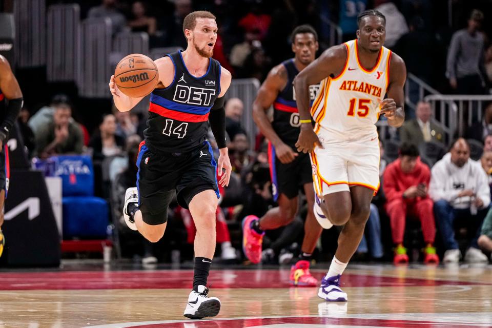 Pistons guard Malachi Flynn dribbles up the court past Hawks center Clint Capela during the second half of the Pistons' 121-113 loss to the Hawks on Wednesday, April 3, 2024, in Atlanta.