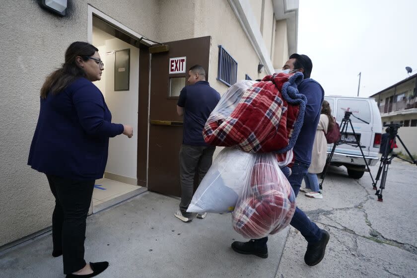 Official bring new blankets into St. Anthony's Croatian Catholic Church in Los Angeles on Wednesday, June 14, 2023. Forty-two migrants, including some children, were dropped off at Union Station around 4 p.m. Wednesday and were being cared for at the church. Texas Gov. Greg Abbott said the migrants were sent to Los Angeles because California had declared itself a "sanctuary" for immigrants. (AP Photo/Damian Dovarganes)