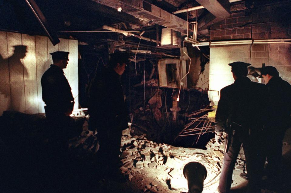 In this Feb. 27, 1993 file photo, Port Authority and New York City Police officers view the damage caused by a truck bomb that exploded in the garage of New York's World Trade Center the previous day. On Thursday, Feb. 26, 2015, officials at the Sept. 11 museum will mark the 22nd anniversary of the 1993 World Trade Center bombing that killed six people and injured more than 1,000. 