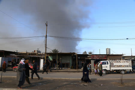 REFILE - CORRECTING DATESmoke from oil wells set ablaze by Islamic State militants before they fled the oil-producing region of Qayyara, Iraq, January 11, 2017. Picture taken January 11, 2017. REUTERS/Girish Gupta