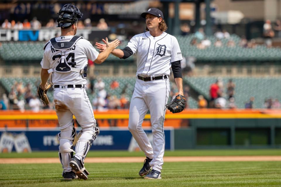 Detroit Tigers catcher Jake Rogers slaps hands with winning relief pitcher Jason Foley (68) at the end of the MLB game against the San Francisco Giants at Comerica Park in Detroit, Michigan on July 24, 2023.