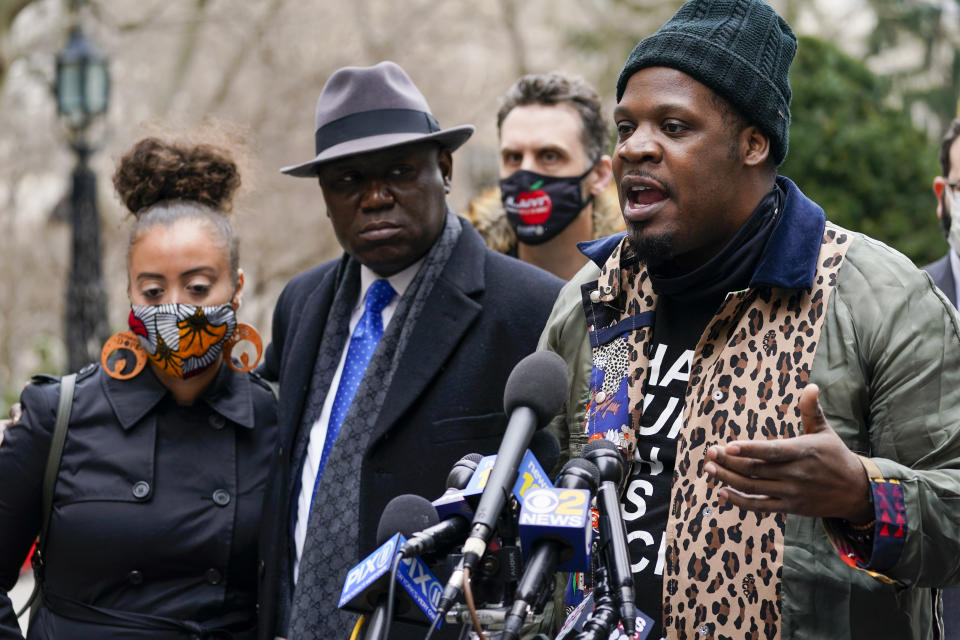 Keyon Harrold Sr., left, is joined by attorney Ben Crump, center, and Katty Rodriguez as he speaks to reporters during a news conference to announce the filing of a lawsuit against Arlo Hotels and Miya Ponsetto, Wednesday, March 24, 2021, in New York. Keyon Harrold and his son were allegedly racially profiled in an Arlo hotel in Manhattan by Miya Ponsetto in December 2020. Ponsetto wrongly accused Keyon Harrold Jr. of stealing her phone and physically attacking him. (AP Photo/Mary Altaffer)