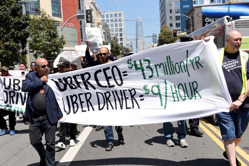 FILE PHOTO: Protestors march through the financial district, demanding fair wages and more transparency during a strike against Uber in San Francisco