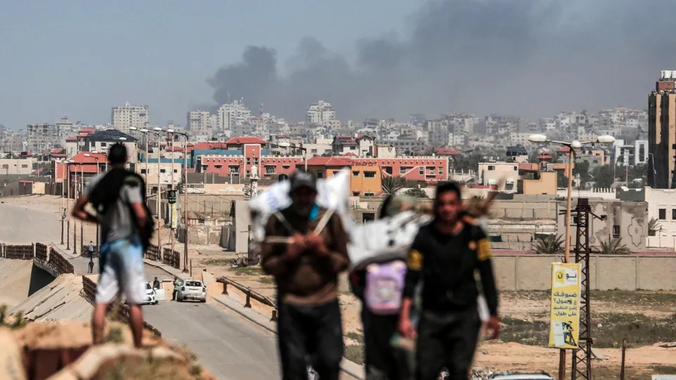 PHOTO: Smoke rises above buildings during Israeli bombardment as people fleeing the Al-Shifa hospital compound and its vicinity in Gaza City, reach the central part of the Gaza Strip on March 21, 2024. (AFP via Getty Images)