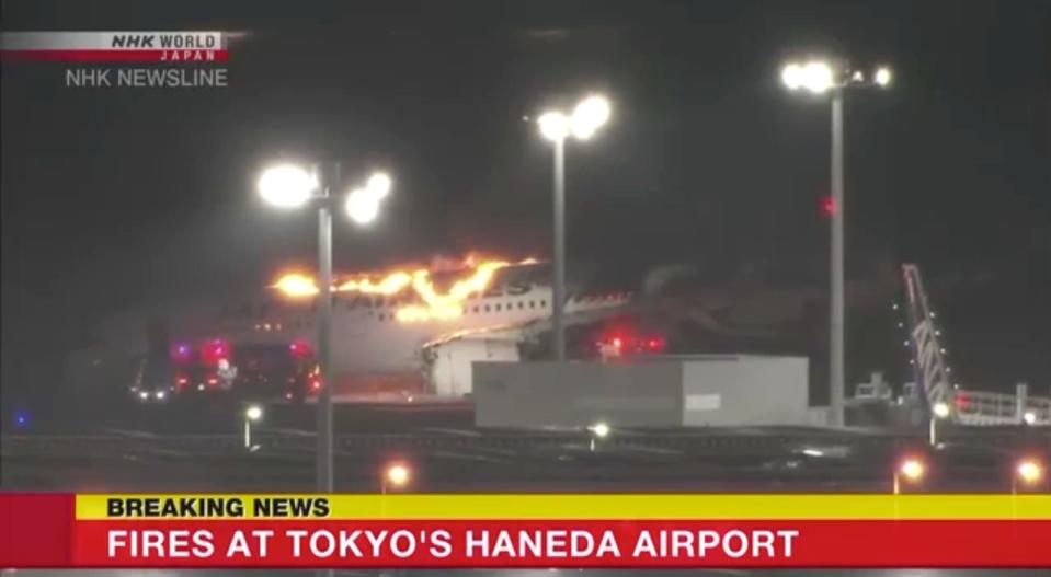 The burning fuselage of Japan Airlines flight 516